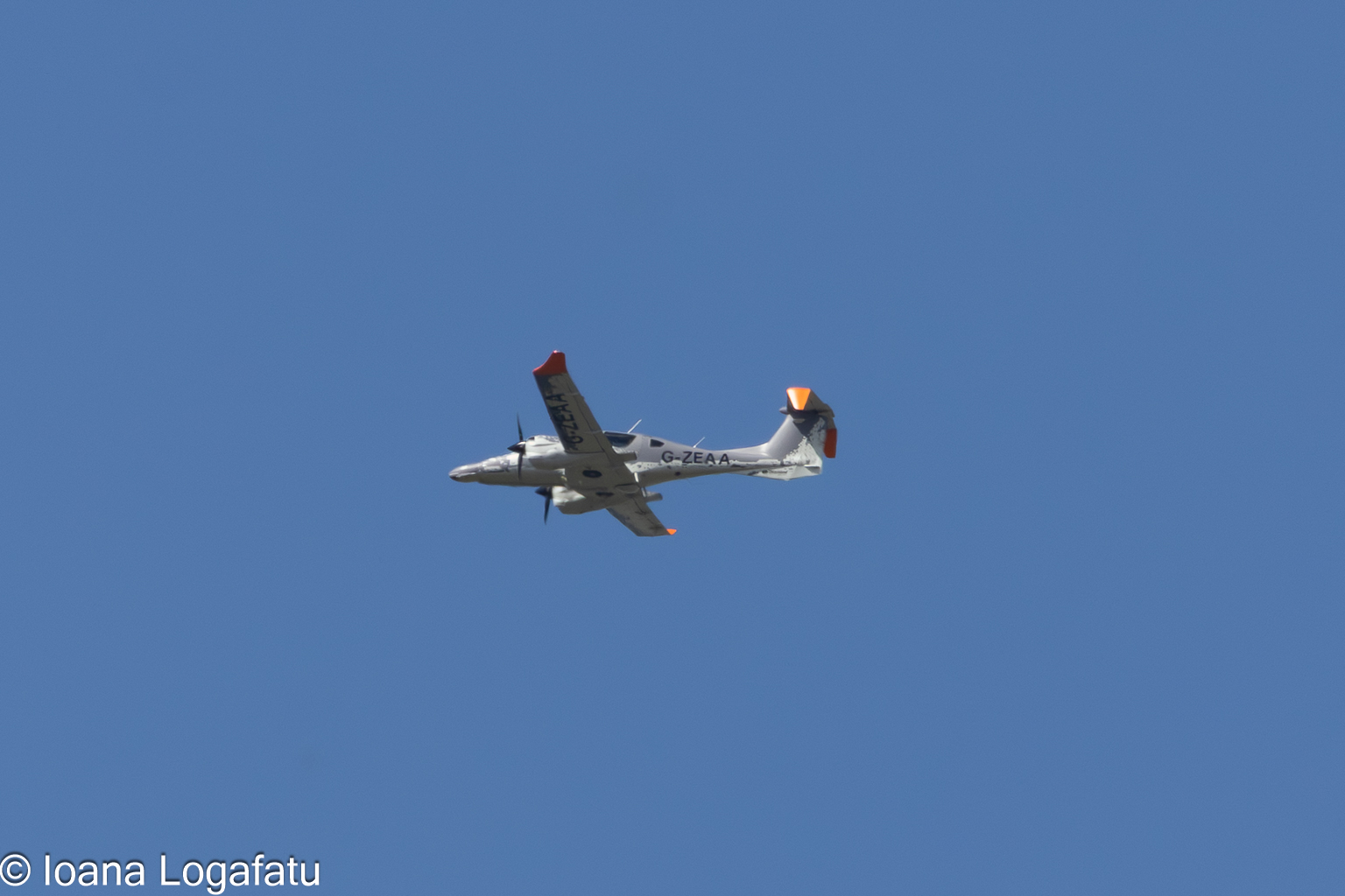 Plane gliding through a clear blue sky above
